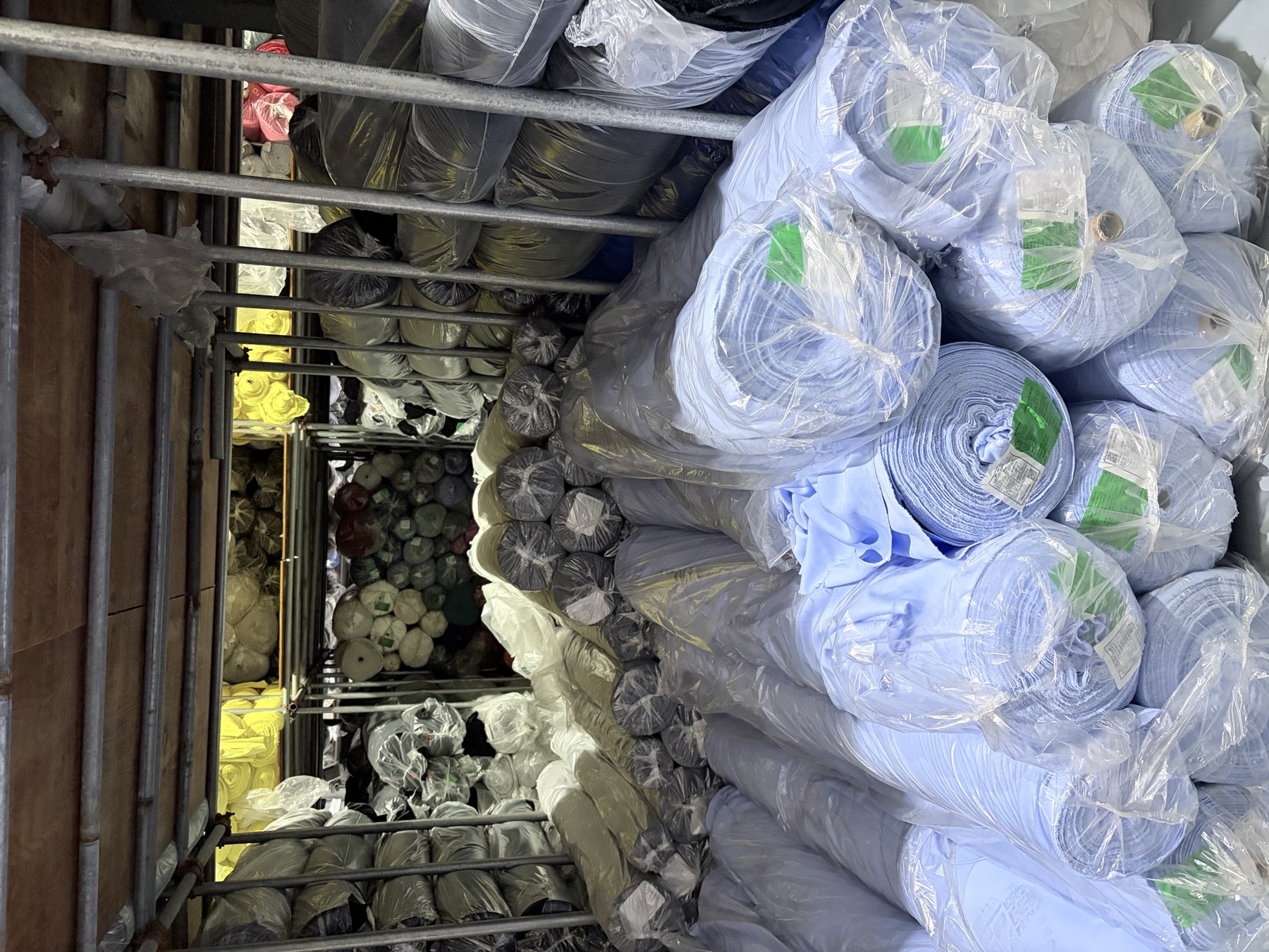 Blue fabric rolls and deeper warehouse storage