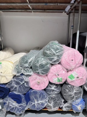Pink, blue and grey surplus fabric rolls