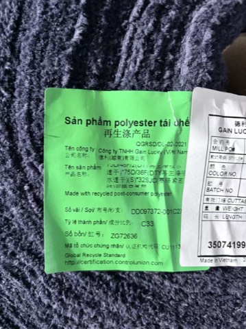 Original material and certification label retained on a fabric roll